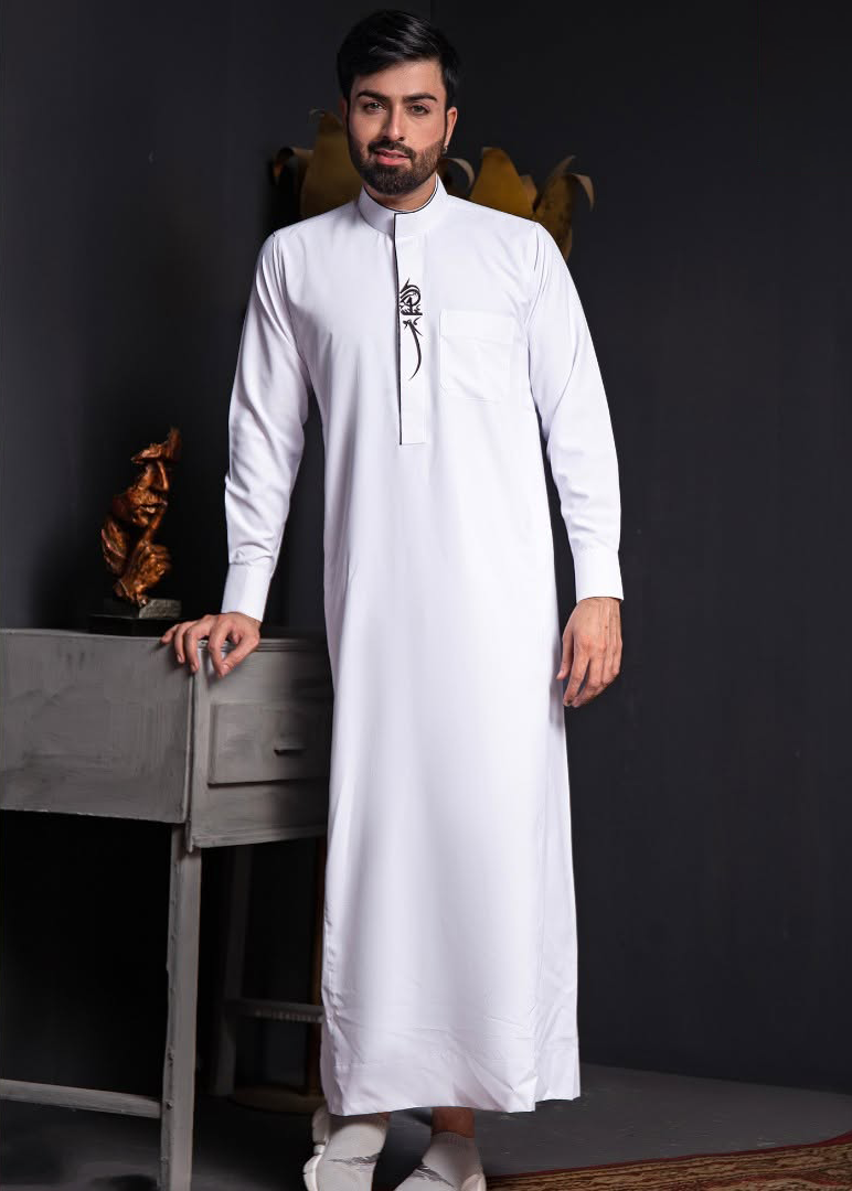 Man wearing a traditional white thobe (Thawb) from Aamsah’s men’s collection, inspired by Saudi, Emirati, Omani, Qatari, Kuwaiti, Moroccan, and Sudanese cultural styles.