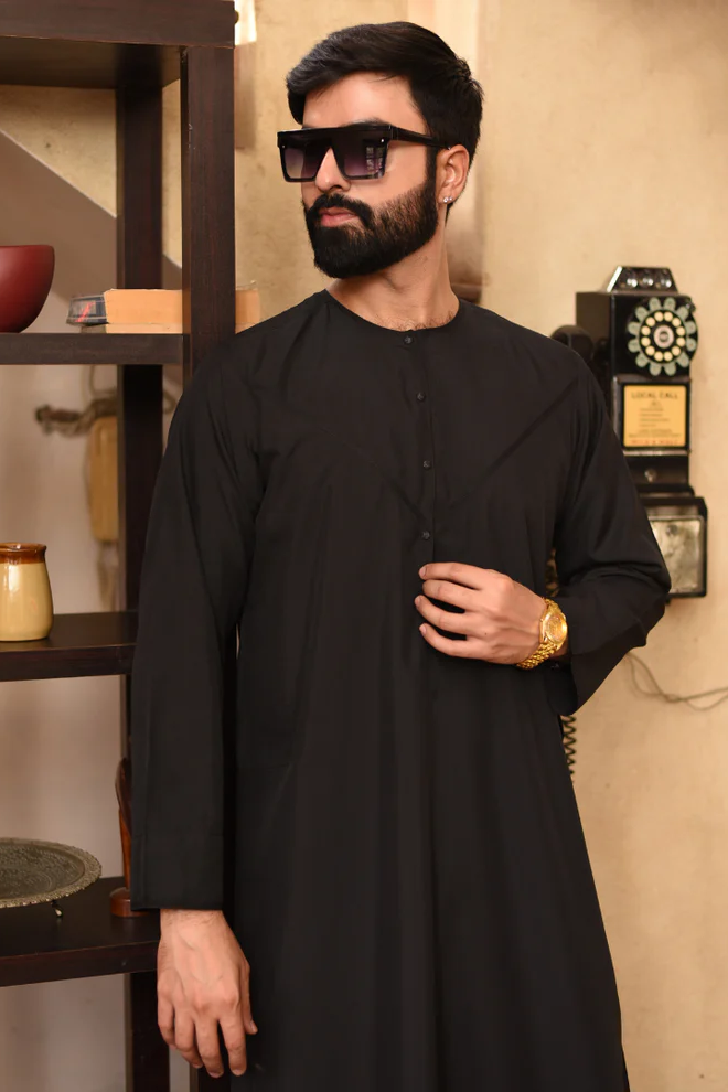 amsah black thobe with minimalist Emirati design, featuring premium imported spun fabric, finest stitching, and a luxurious finish for formal and casual occasions.
