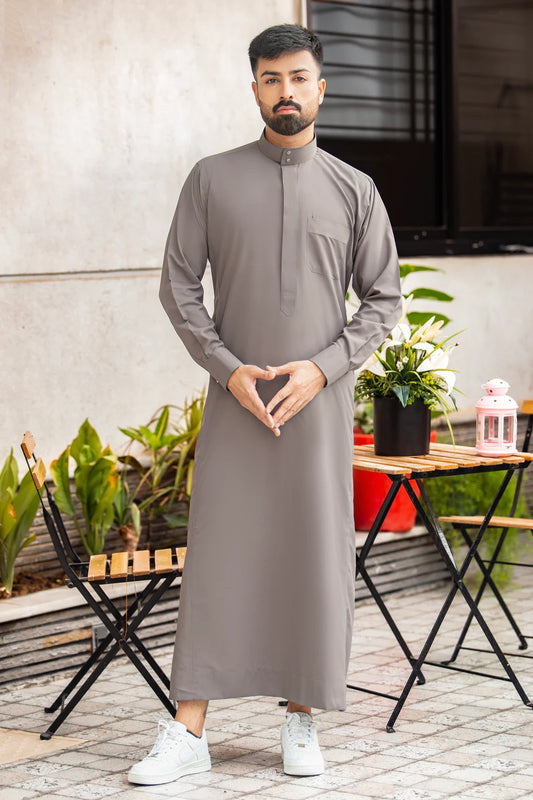 Elegant light gray Kuwaiti thobe with a front pocket and Saudi collar, tailored for men, showcasing premium fabric and flawless stitching. Competitors include Shukr and Sunnah Style.